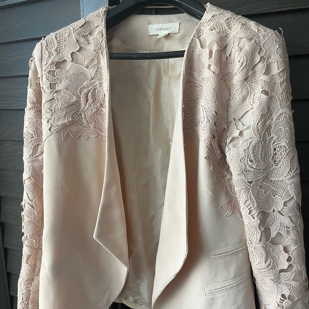 Beautiful blush pink blazer with laser cut lace sleeves and shoulder detail!